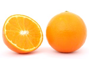 A whole orange fruit sits next to a half orange on a white background.