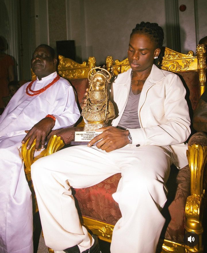 Rema with an award given to him by the Oba of Benin on his Homecoming 