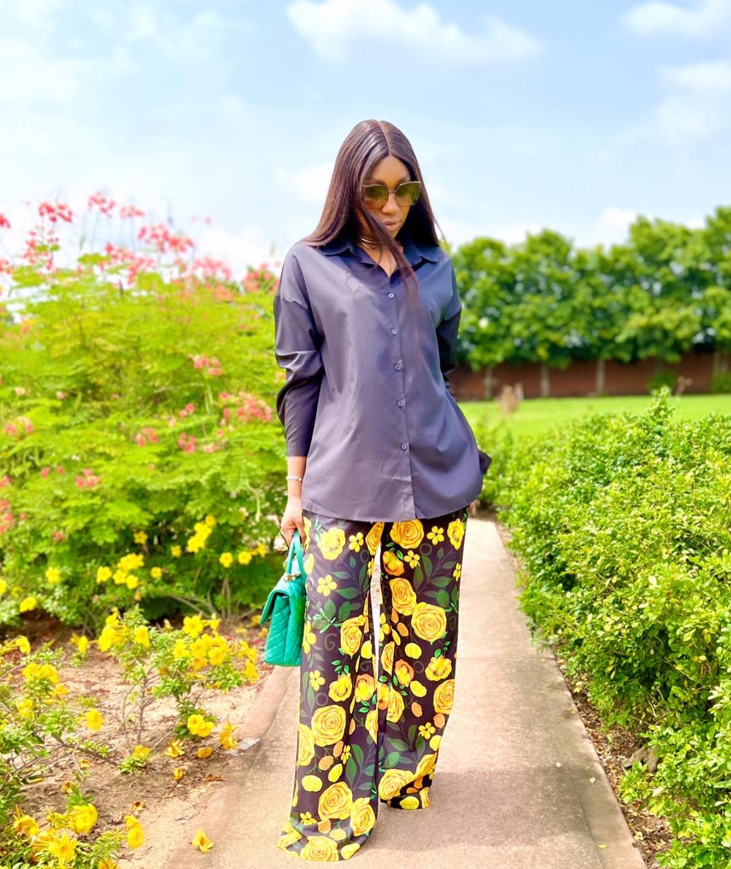 Ebube Nwagbo in an Ankara print trousers and a button-down shirt