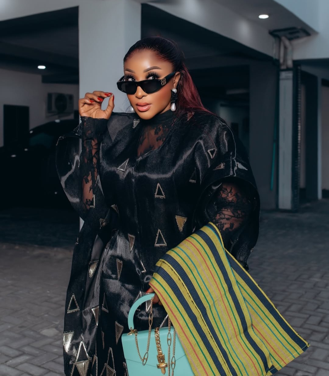 Ini Edo wearing a luxurious black and gold geometric-patterned Trish O Couture outfit