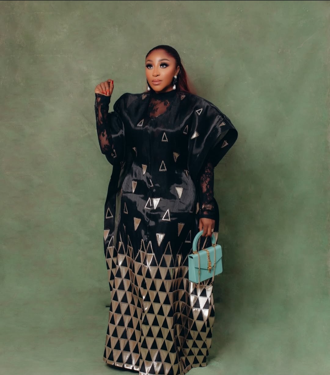 Ini Edo wearing a luxurious black and gold geometric-patterned Trish O Couture outfit