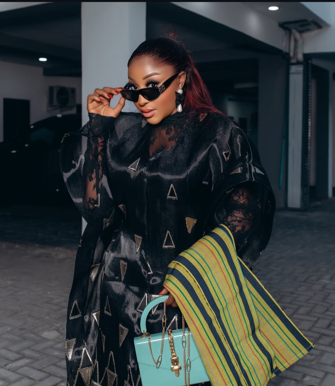 Ini Edo wearing a luxurious black and gold geometric-patterned Trish O Couture outfit