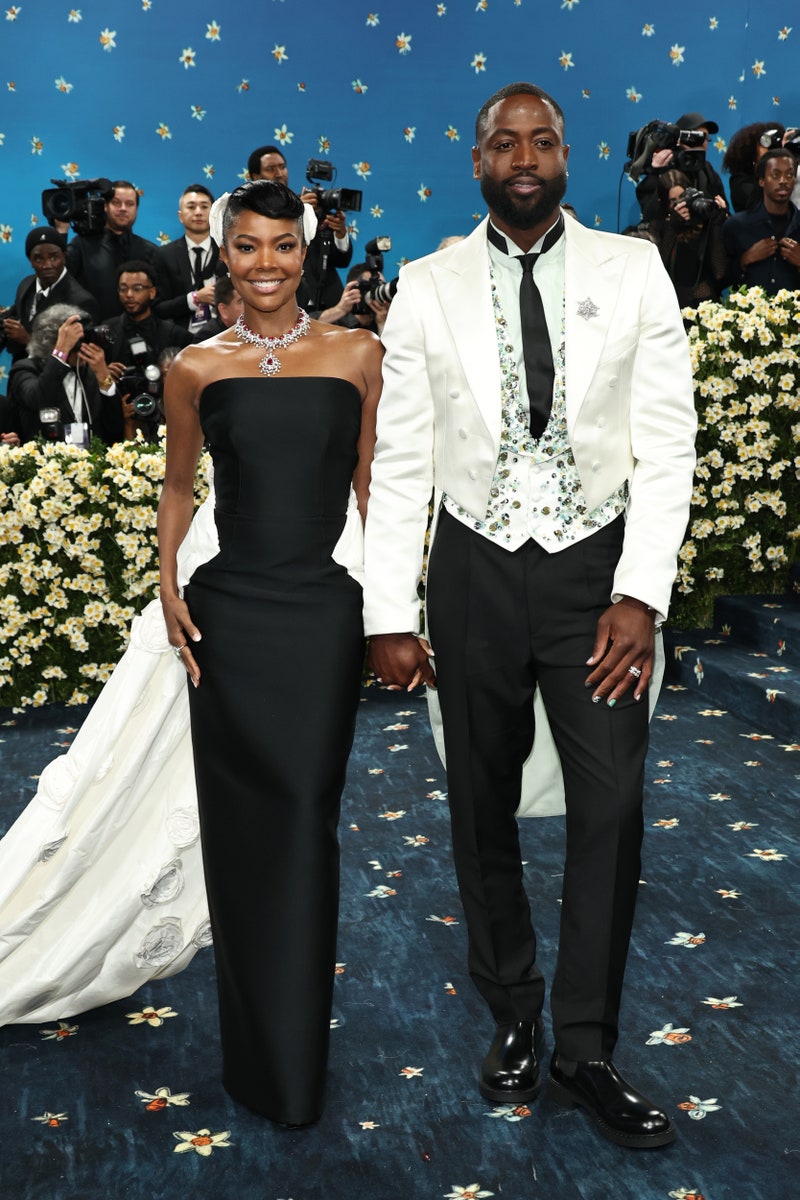 Celebrity Couple Names\] posing together on the 2025 Met Gala red carpet.