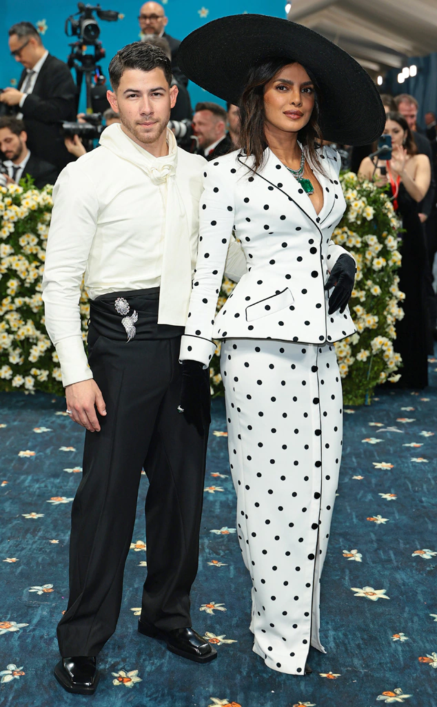 Celebrity Couple Names\] posing together on the 2025 Met Gala red carpet.