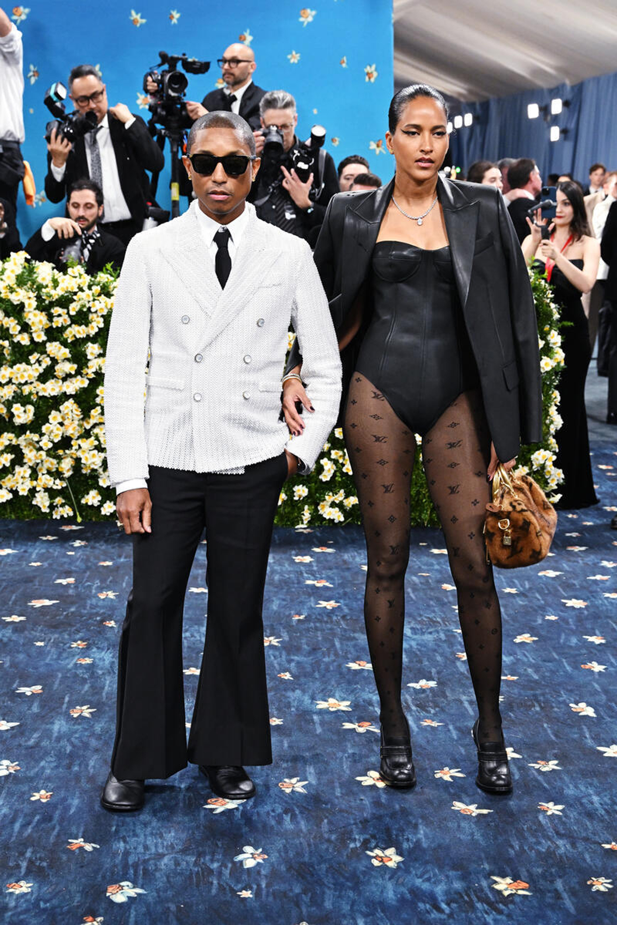 Celebrity Couple Names\] posing together on the 2025 Met Gala red carpet.