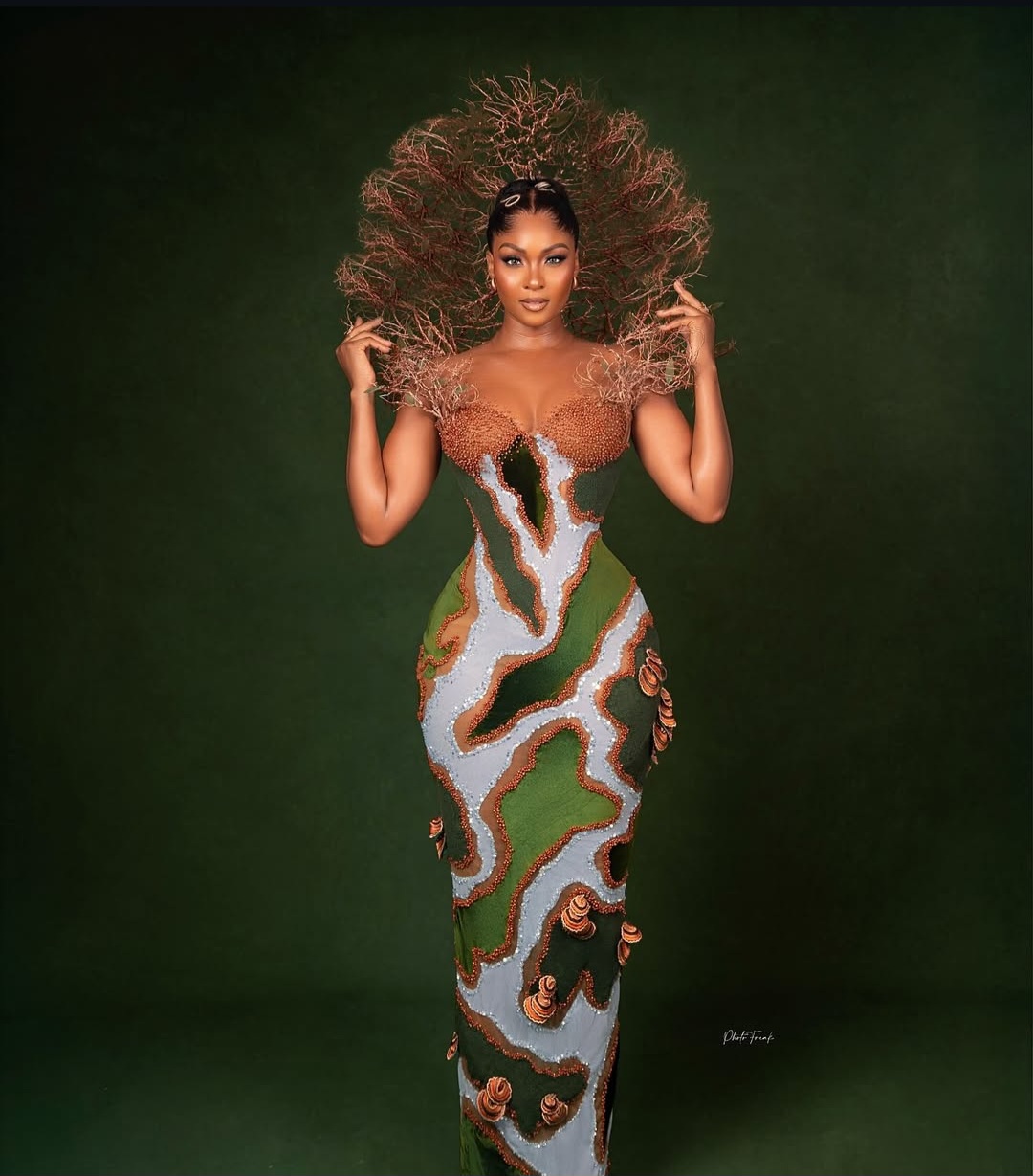 "Nigerian celebrity in a glamorous, custom-made outfit posing on the AMVCA 2025 red carpet