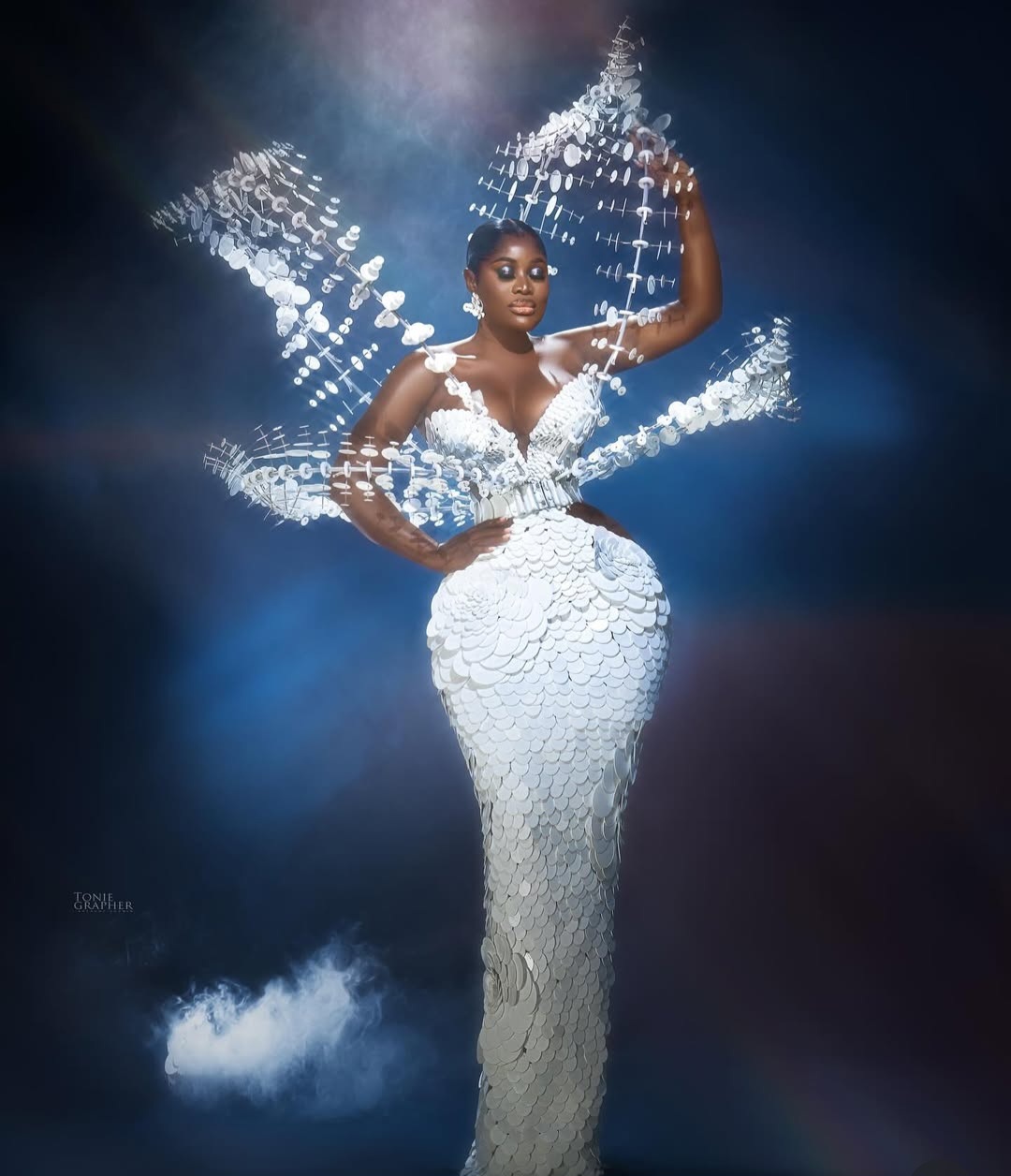 "Nigerian celebrity in a glamorous, custom-made outfit posing on the AMVCA 2025 red carpet