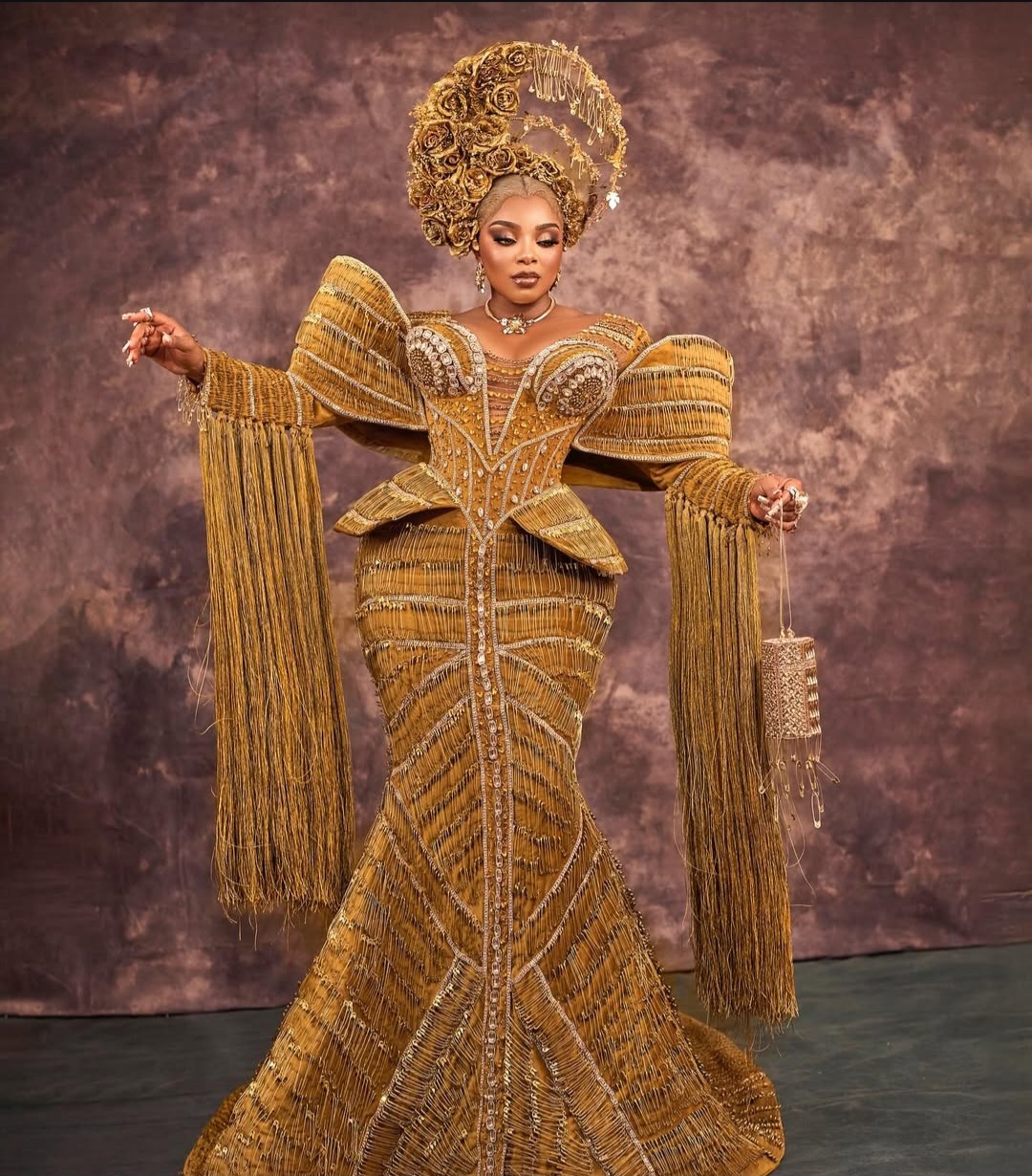 "Nigerian celebrity in a glamorous, custom-made outfit posing on the AMVCA 2025 red carpet
