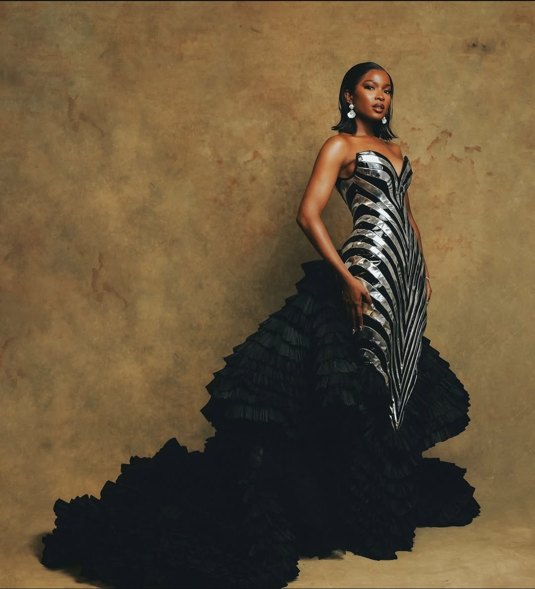 "Nigerian celebrity in a glamorous, custom-made outfit posing on the AMVCA 2025 red carpet