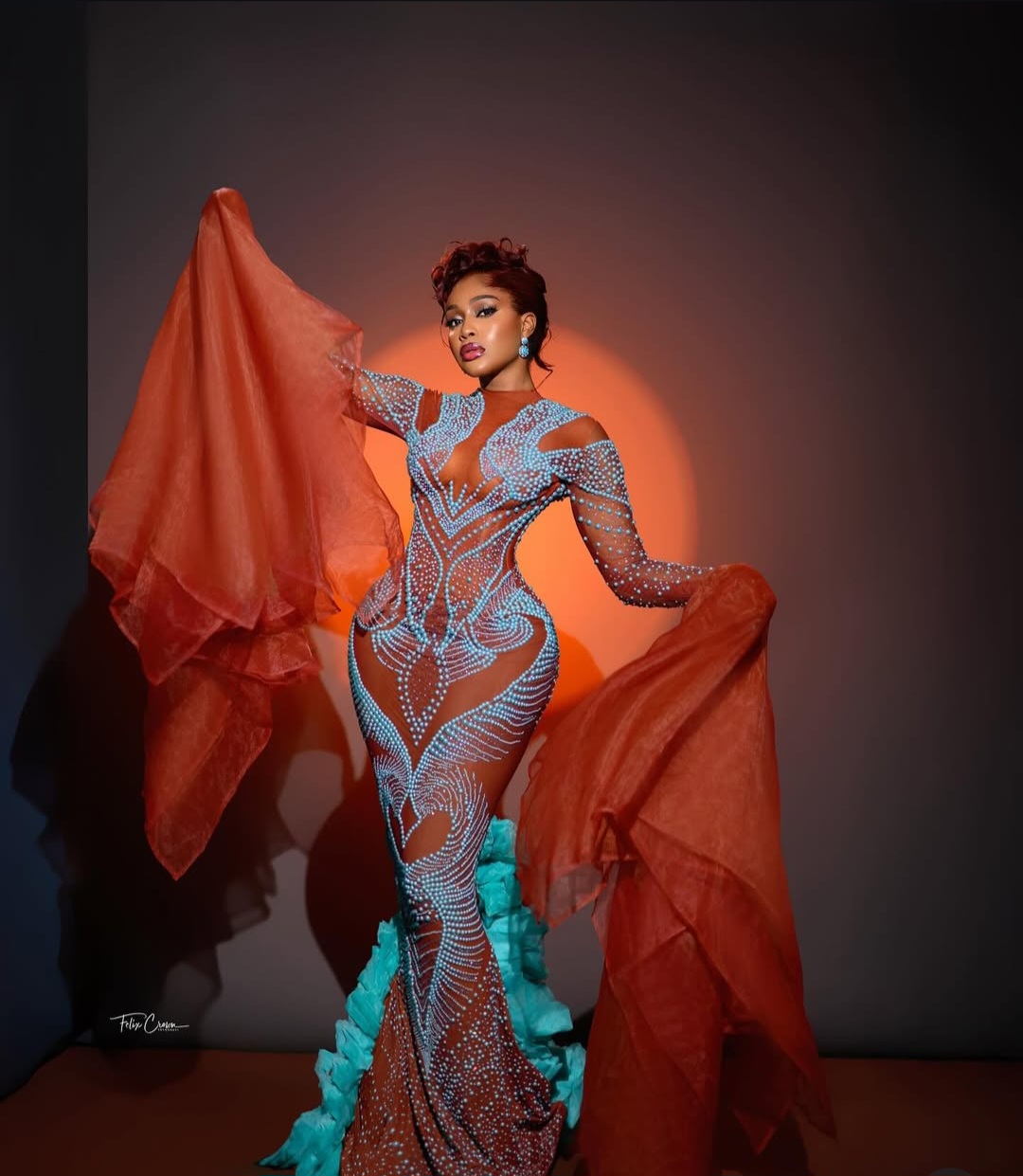 "Nigerian celebrity in a glamorous, custom-made outfit posing on the AMVCA 2025 red carpet
