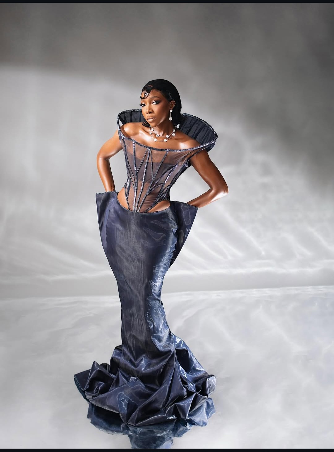 "Nigerian celebrity in a glamorous, custom-made outfit posing on the AMVCA 2025 red carpet