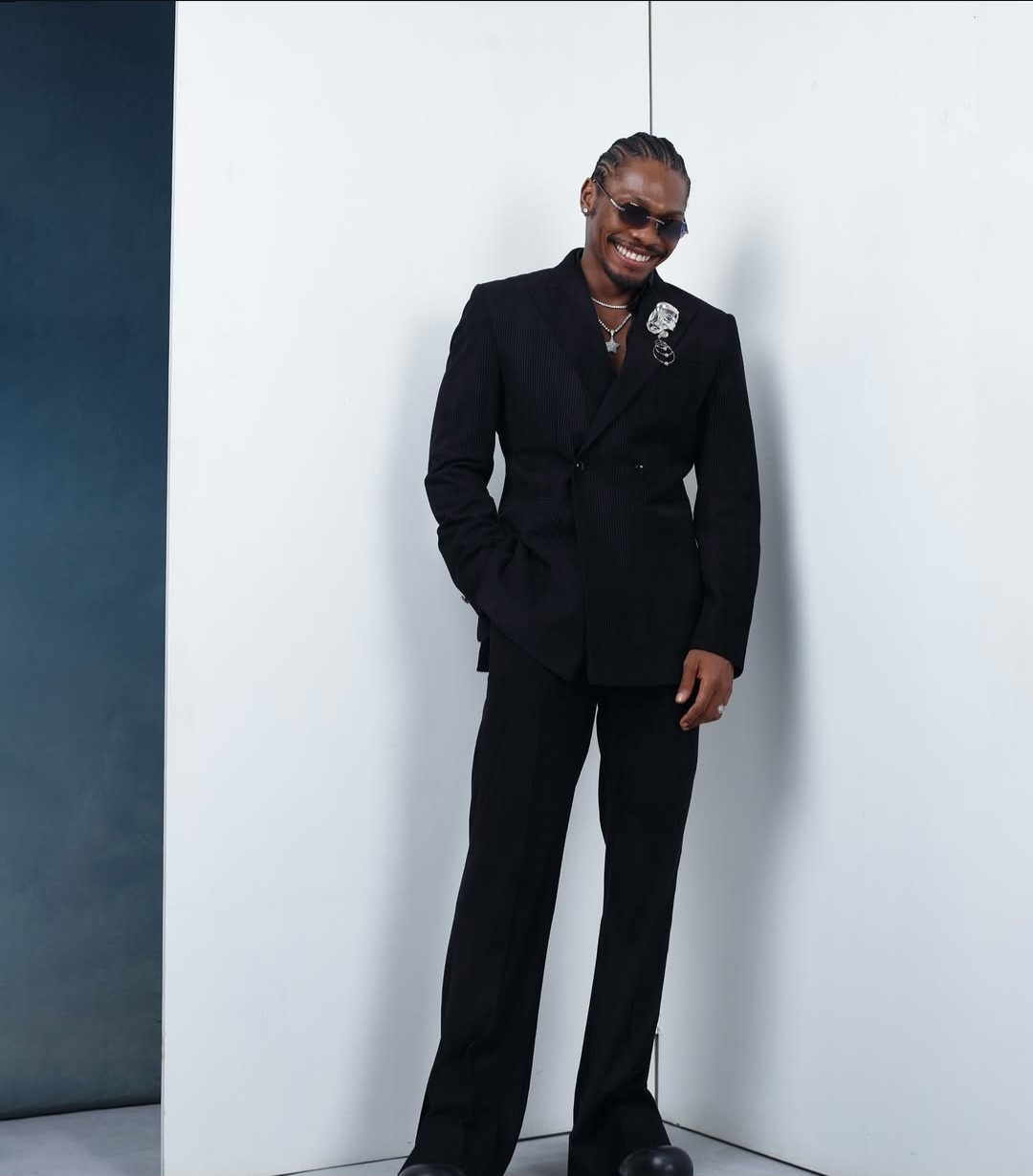 "Nigerian celebrity in a glamorous, custom-made outfit posing on the AMVCA 2025 red carpet