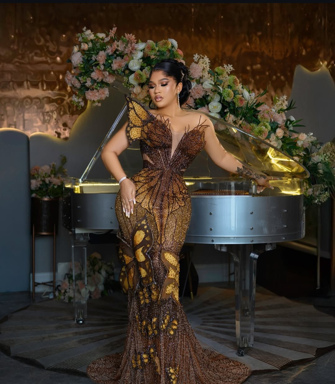 "Nigerian celebrity in a glamorous, custom-made outfit posing on the AMVCA 2025 red carpet