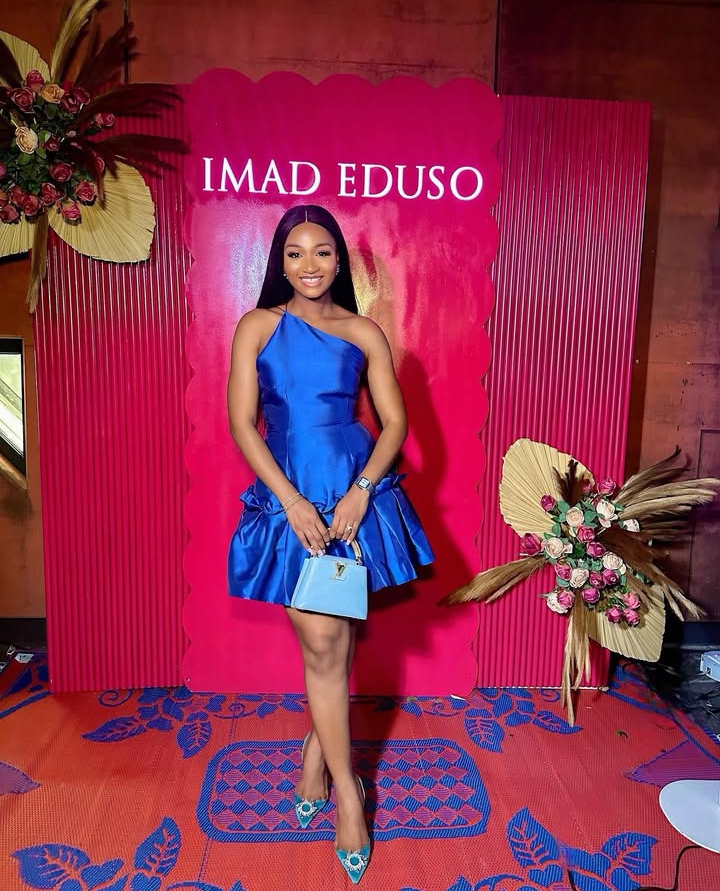 Powede Eniola in a bright blue dress