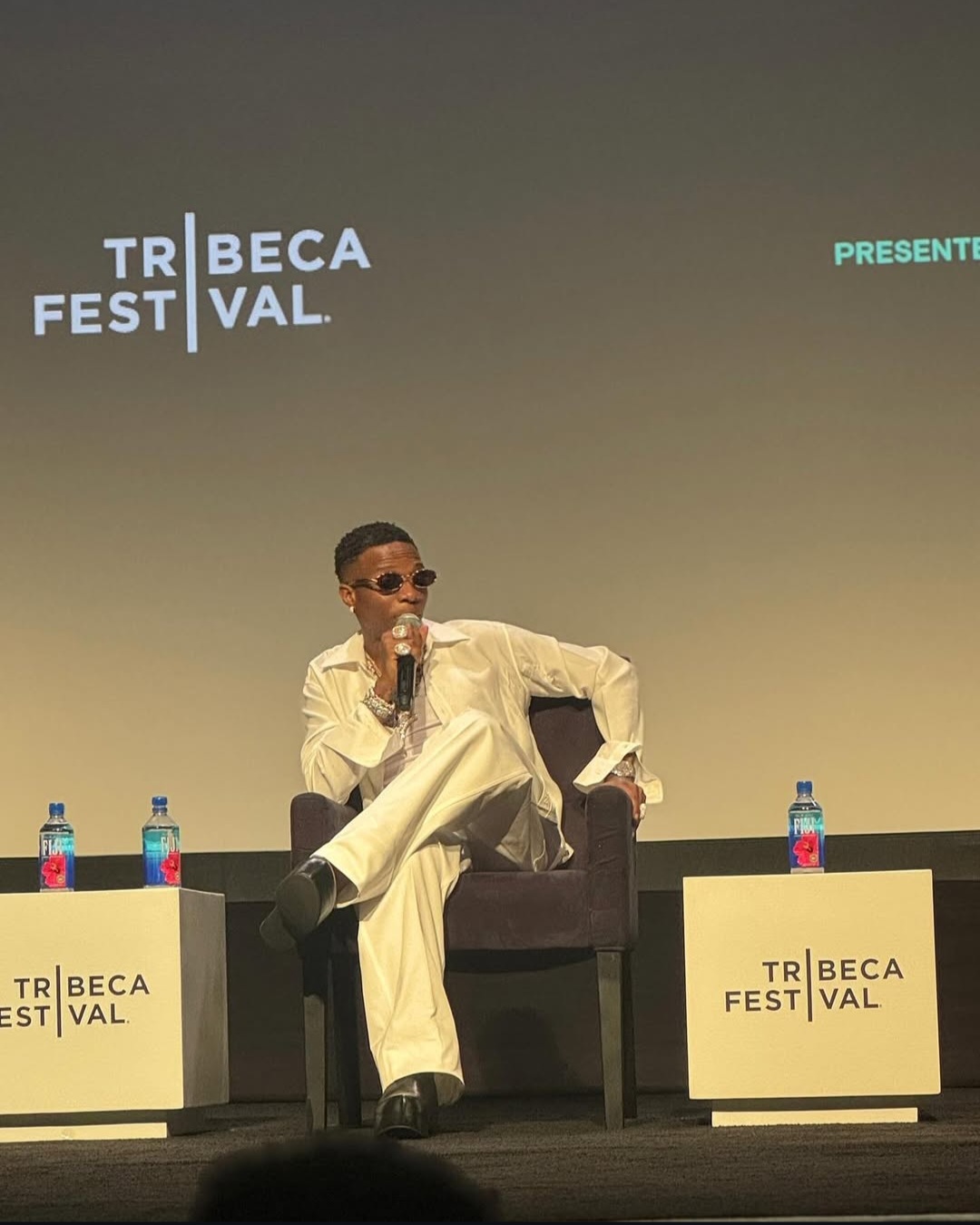 Wizkid smiles alongside partner Jada Pollock and their daughter on the red carpet