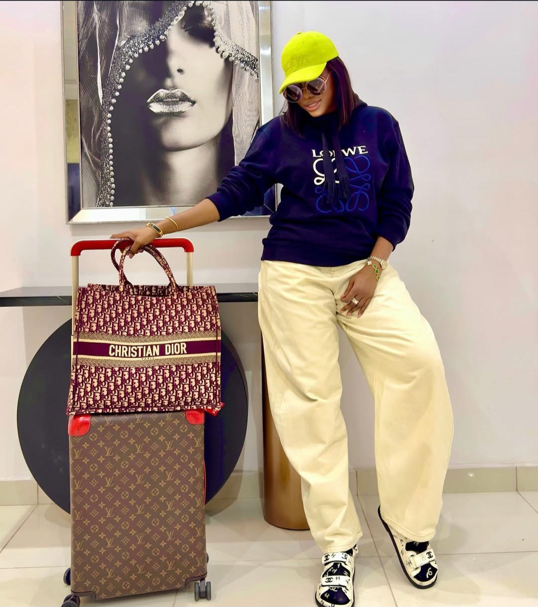 Medlinboss wearing a neon green LOEWE cap, navy LOEWE hoodie